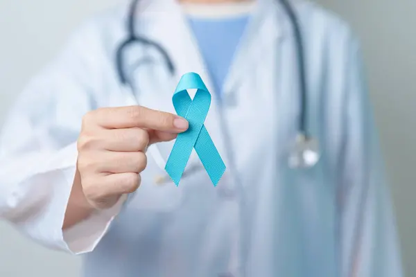 Blue November Prostate Cancer Awareness month, Doctor with Blue Ribbon in hospital for support people life and illness. Healthcare, International men, Father, Diabetes and World cancer day
