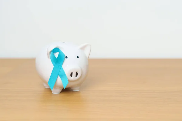 Blue November Prostate Cancer Awareness month, Blue Ribbon with Piggy Bank for support illness life. Health, Donation, Charity, Campaign, Money Saving, Fund, International men, Father and Diabetes