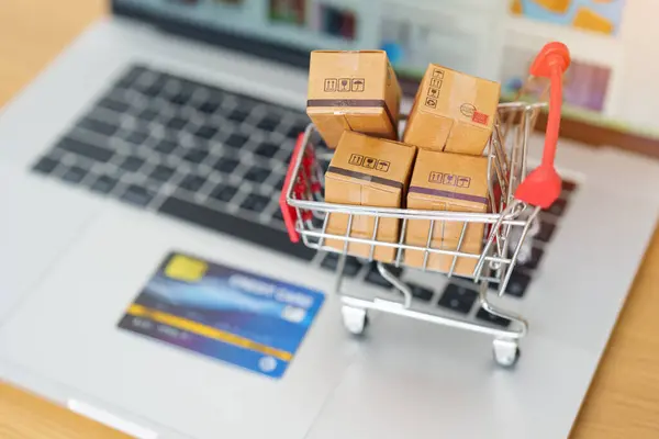 Boxes with credit card on a laptop computer. online shopping, Marketplace platform website, technology, ecommerce, shipping delivery, logistics and online payment concepts
