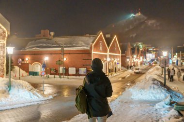 Hakodate 'de turist ziyareti, Kazaklı Gezgin kışın Snow' la Kanemori Kırmızı Tuğla Deposu 'nu geziyor. Hokkaido, Japonya 'da önemli ve popüler. Seyahat ve Tatil konsepti.