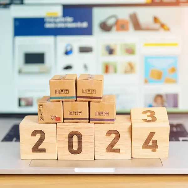 2024 New Year Online Shopping concept. Shipping Boxes on laptop computer. Sale and discount during Christmas and New Year holiday, ecommerce, shipping delivery, logistics and Cyber Monday