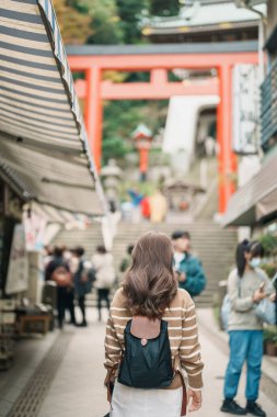 Enoshima Adası, Fujisawa, Kanagawa, Japonya 'da kadın turist ziyareti. Gezginler Enoshima Tapınağı 'nı gezerken mutlu. Tokyo yakınlarındaki turistler için önemli ve popüler bir yer. Seyahat ve Tatil kavramı