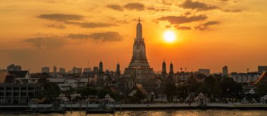 Gün batımında Wat Arun Tapınağı, Chao Phraya nehrinin yanında Şafak Tapınağı. Kent simgesi ve Bangkok, Tayland ve Güneydoğu Asya 'daki turizm ve turizm merkezleriyle ünlüdür.