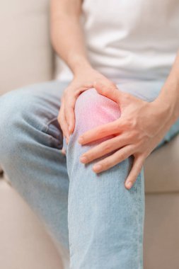 woman having knee ache and muscle pain due to Runners Knee or Patellofemoral Pain Syndrome, osteoarthritis, arthritis, rheumatism and Patellar Tendinitis. medical concept