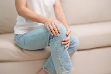 woman having knee ache and muscle pain due to Runners Knee or Patellofemoral Pain Syndrome, osteoarthritis, arthritis, rheumatism and Patellar Tendinitis. medical concept