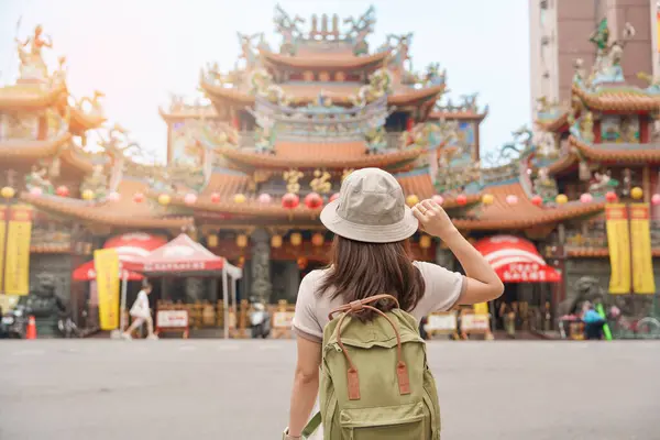 woman traveler visiting in Taiwan, Tourist sightseeing in Songshan Ciyou Temple, near Raohe Night Market, Songshan District, Taipei City. landmark and popular. Travel and Vacation concept