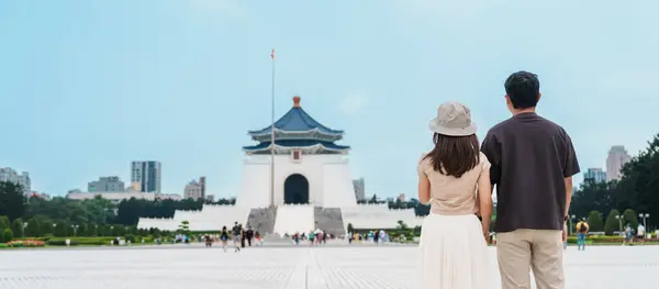 Couple traveler visiting in Taiwan, Tourist sightseeing in National Chiang Kai shek Memorial or Hall Freedom Square, Taipei City. trip, love, together and summer vacation concept