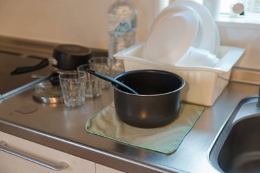 Modern mutfak içinde ocak, kap, tabak ve cam var. Mutfak gereçleri, yemek takımı, yaşam tarzı yerli konsept.