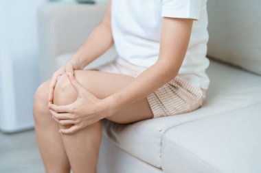 woman having knee ache and muscle pain due to Runners Knee or Patellofemoral Pain Syndrome, osteoarthritis, arthritis, rheumatism and Patellar Tendinitis. medical concept