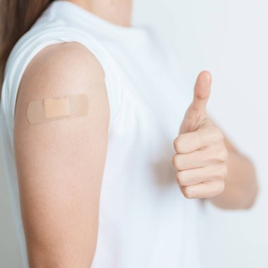 Woman with bandage after receiving vaccine. Vaccination and Immunization for Influenza, HPV, Zoster, IPD, DTP or Diphtheria, Tetanus and Pertussis, MMR, Hepatitis B, Covid  and Varicella vaccine clipart