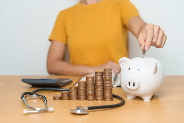 stock image Money Saving, Health Insurance, Medical, Donation and Financial concepts. woman with coins stack and piggy bank and stethoscope, Money stack Counting arrangement for deposit and Healthcare cost