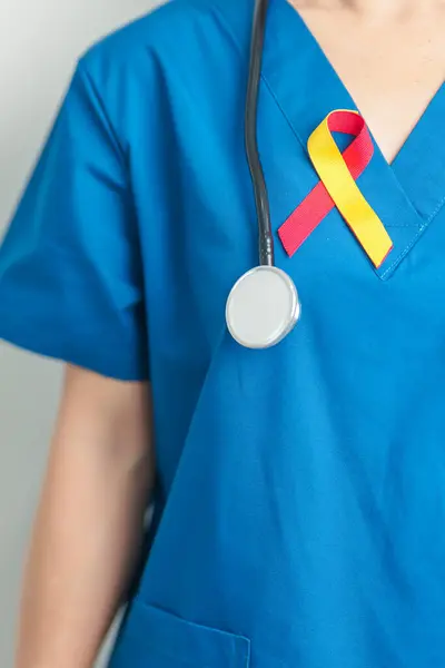 stock image World hepatitis day awareness month, 28 July. Doctor holding Red and Yellow ribbon. Liver cancer, Jaundice, Cirrhosis, Failure, Enlarged, Hepatic Encephalopathy and Health concept