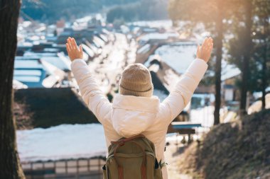 Ouchi Juku 'nun kışın karlı köyünü gezen turist, Shimogo kasabası, Minamiaizu, Fukushima Bölgesi, Tohoku Bölgesi, Japonya' ya seyahat ediyor. Yer imi ve boşluk