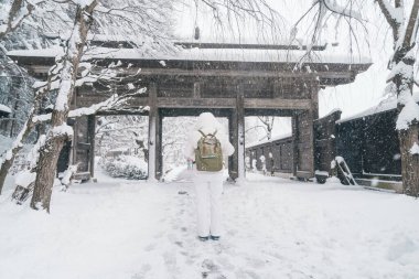 Woman tourist sightseeing Yamadera temple with snow in winter, traveler travel Risshakuji temple in Yamagata City, in Yamagata Prefecture, Tohuku, Japan. Landmark for tourists attraction in Japan clipart