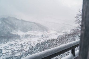 view of village with snow in winter from mountain viewpoint of Yamadera temple, the popular name for the Buddhist temple of Risshakuji located in Yamagata City, in Yamagata Prefecture, Tohuku, Japan clipart