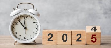 Klasik çalar saatle ve 2024 'ü 2025 blok ile mutlu yıllar. Noel, Yeni Başlangıç, Çözüm, Geri sayım, Hedefler, Planlar, Eylem ve Motivasyon Konsepti