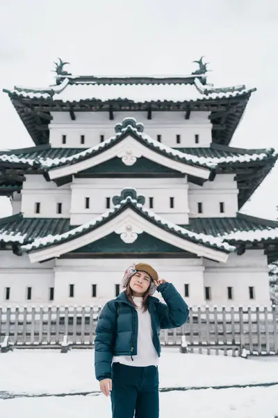 stock image Woman tourist sightseeing Hirosaki Castle in winter, happy traveler travel Hirosaki city, Aomori Prefecture, Tohoku, Japan. Landmark and famous for tourist attraction. Japan travel and vacation