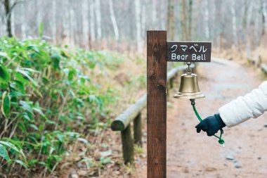 Woman tourist travel Kamikochi National Park, happy Traveler with Bear bell in the forest, Nagano Prefecture, Japan. Landmark for tourists attraction. Japan Travel, Destination and Vacation clipart