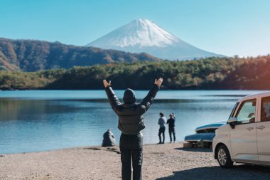 Saiko Gölü 'nde Fuji Dağı' nın keyfini çıkaran kadın turistler, Fuji Dağı 'nı gezen mutlu gezginler ve Fuji Beş Gölleri gezisi. Turistler için dönüm noktası. Japonya Seyahat, Varış ve Tatil