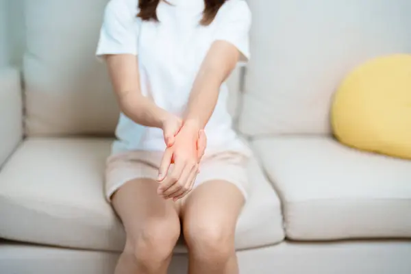 stock image Woman having wrist pain at home, muscle ache due to De Quervain s tenosynovitis, ergonomic, Carpal Tunnel Syndrome or Office syndrome and Parkinson disease concept