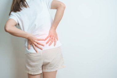 Evde sırt ağrısı çeken bir kadın. Piriforis Sendromu, bel ağrısı ve omurga baskısı nedeniyle kas ağrısı olan yetişkin bir kadın. Ofis sendromu ve tıbbi konsept