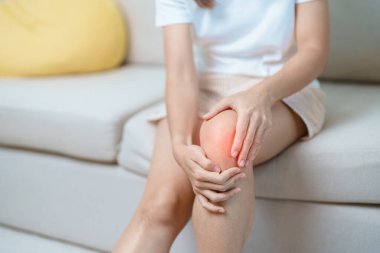 woman having knee ache and muscle pain due to Runners Knee or Patellofemoral Pain Syndrome, osteoarthritis, arthritis, rheumatism and Patellar Tendinitis. medical concept