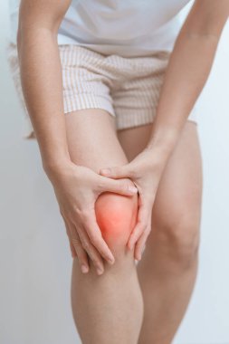 woman having knee ache and muscle pain due to Runners Knee or Patellofemoral Pain Syndrome, osteoarthritis, arthritis, rheumatism and Patellar Tendinitis. medical concept