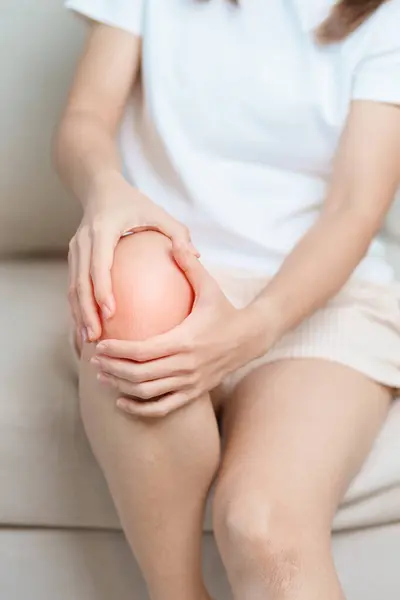 stock image woman having knee ache and muscle pain due to Runners Knee or Patellofemoral Pain Syndrome, osteoarthritis, arthritis, rheumatism and Patellar Tendinitis. medical concept