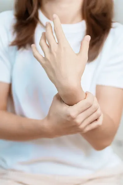 stock image Woman having wrist pain at home, muscle ache due to De Quervain s tenosynovitis, ergonomic, Carpal Tunnel Syndrome or Office syndrome and Parkinson disease concept