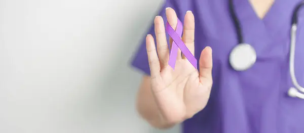 stock image Doctor holding purple Ribbon for Violence, Pancreatic, Esophageal, Testicular cancer, Alzheimer, epilepsy, lupus, Sarcoidosis and Fibromyalgia. Awareness month and World cancer day concept