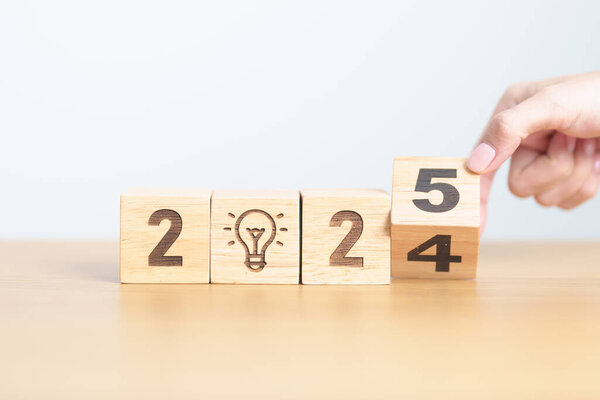 2024 year change to 2025 year block with lightbulb. Business Idea, Creative, Thinking, brainstorm, Goal, Resolution, strategy, plan, Action, change and New Year start concepts