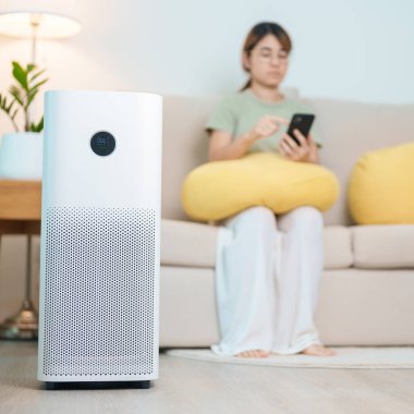 Air Purifier with woman relax and use smartphone on sofa. Purification system for filter and cleaning dust PM2.5 HEPA and virus in home. Allergy, Pure air, health, Wellness lifestyle and Air Pollution clipart