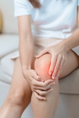 woman having knee ache and muscle pain due to Runners Knee or Patellofemoral Pain Syndrome, osteoarthritis, arthritis, rheumatism and Patellar Tendinitis. medical concept