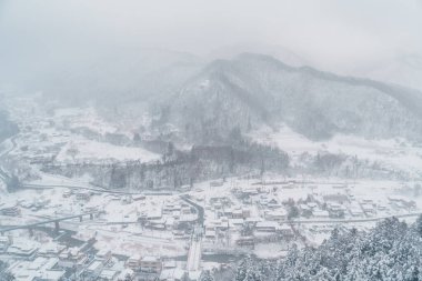 view of village with snow in winter from mountain viewpoint of Yamadera temple, the popular name for the Buddhist temple of Risshakuji located in Yamagata City, in Yamagata Prefecture, Tohuku, Japan clipart