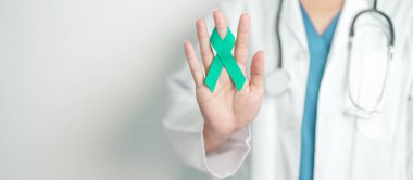 Doctor holding Teal Ribbon for January Cervical Cancer Awareness month. Uterus and Ovaries, Cervix, Endometriosis, Hysterectomy, Uterine fibroids, Reproductive, Healthcare and World cancer day clipart