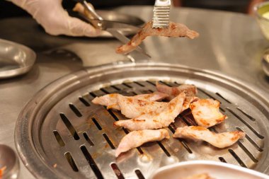 Chef Grilling meat pork on stove serve in restaurant. Korean food and BBQ traditional style clipart