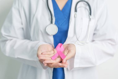 Pembe Ekim Göğüs Kanseri Bilinci Ayı, Pembe Kurdeleli kadın doktor, insanların hayatını ve hastalıklarını desteklemek için hastanede. Ulusal Kanserden kurtulanlar ayı, Anne ve Dünya Kanser Günü konsepti