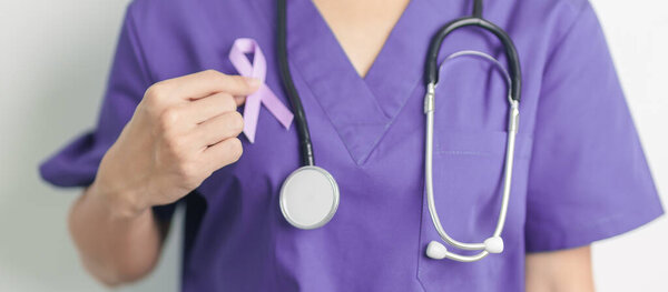 Doctor holding purple Ribbon for Violence, Pancreatic, Esophageal, Testicular cancer, Alzheimer, epilepsy, lupus, Sarcoidosis and Fibromyalgia. Awareness month and World cancer day concept