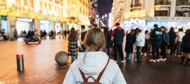 woman traveler visiting in Shanghai, China. Happy Female Tourist sightseeing in Nanjing road, shopping district of Shanghai. landmark and popular for tourism attractions. Travel and Vacation concept clipart