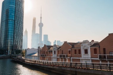 Cityscape view of Shanghai city in the morning. Skyscraper of Lujiazui in Pudong, view from Hongkou Gang canal of Shanghai, China. landmark and popular for tourism attraction. Travel and vacation  clipart