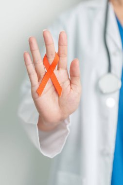 Doctor with Orange Ribbon for Leukemia, Kidney cancer day, world Multiple Sclerosis, CRPS, Self Injury Awareness month. Healthcare and word cancer day concept clipart