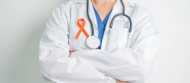 Doctor with Orange Ribbon for Leukemia, Kidney cancer day, world Multiple Sclerosis, CRPS, Self Injury Awareness month. Healthcare and word cancer day concept clipart