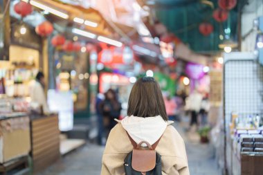 Tayvan 'da gezgin bir kadın, sırt çantalı bir turist Jiufen Old Street pazarını geziyor ve alışveriş yapıyor. Taipei şehrinin yakınlarındaki popüler bir yer ve eğlence merkezi. Seyahat ve Tatil kavramı