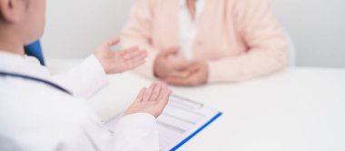 Hastane randevusu sırasında yaşlı hastaya teşhis ve tedavi planını açıklayan doktor. Kıdemli hasta doktordan hastalığa konuşuyor. Tıbbi danışmanlık, yaşlılık bakımı, sağlık konsepti 