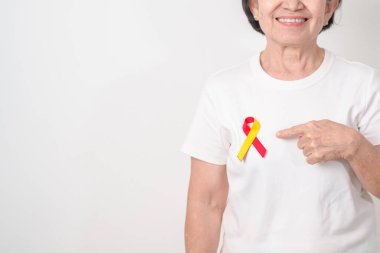 Dünya Hepatit Günü farkındalık ayı, 28 Temmuz. Kırmızı ve sarı kurdeleli yaşlı kadın. Karaciğer kanseri, sarılık, siroz, başarısızlık, büyüme, Hepatik Ensefalopati ve Sağlık Konsepti