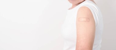 Elderly Woman with bandage after received vaccine. Vaccination and Immunization for Influenza, Herpes Zoster, Tetanus, Covid 19 booster, Dengue, Encephalitis, Rabies, Pneumococcal, IPD, RSV Vaccines 