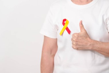 Dünya Hepatit Günü farkındalık ayı, 28 Temmuz. Kırmızı ve sarı kurdeleli yaşlı kadın. Karaciğer kanseri, sarılık, siroz, başarısızlık, büyüme, Hepatik Ensefalopati ve Sağlık Konsepti