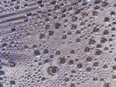 Beyaz arkaplan dokusuna su damlaları. Arkaplan camı su damlalarıyla kaplı. Sudaki kabarcıklar