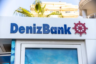 Alanya, Turkey - 21 July 2021: Deniz Bank logo on a shore city residence building with an ATM.