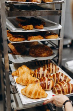 Photo in the bakery, delicious French croissants, croissants with chocolate, bread, dish with berries.